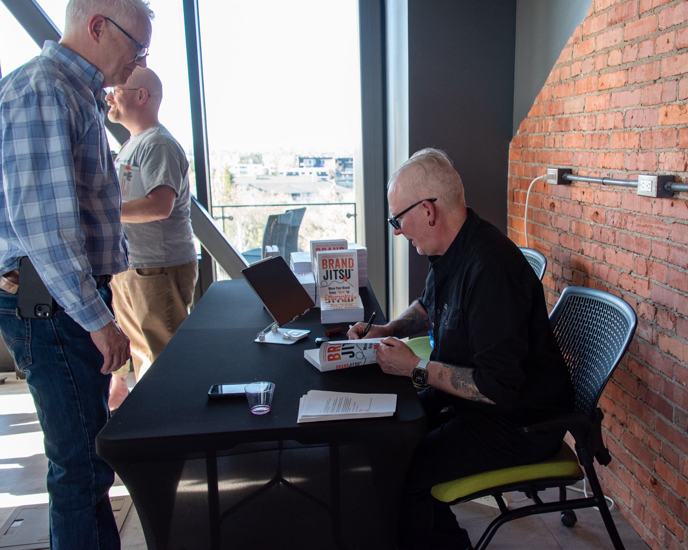 Michael Dargie signing copies of BrandJitsu® at the book launch